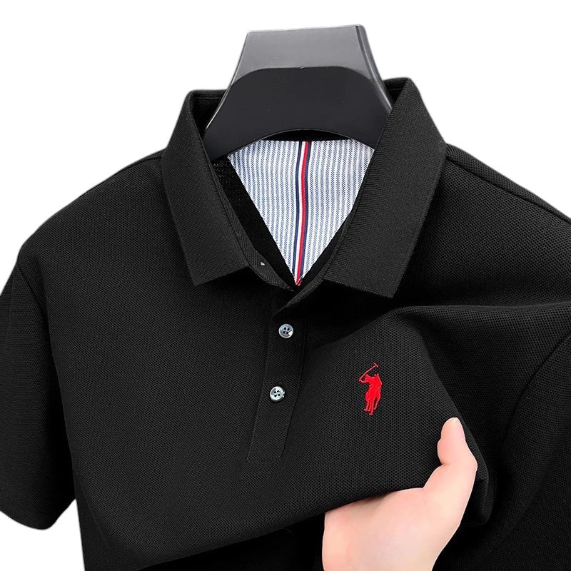 COMFORTS black pique knit short sleeve polo shirt with red embroidered logo and striped inner collar